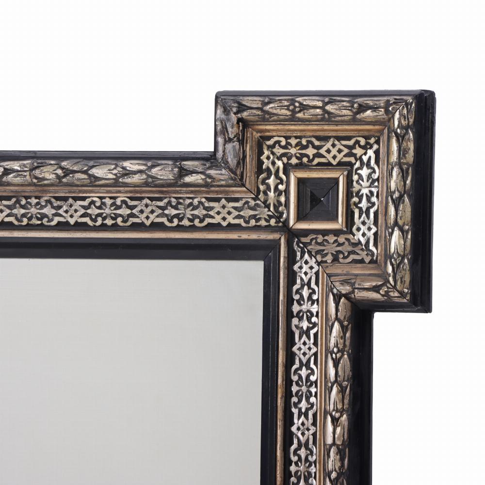 This elegant frame with projecting corners surrounding a rectangular mirror will be a perfect accent on your entry wall. 