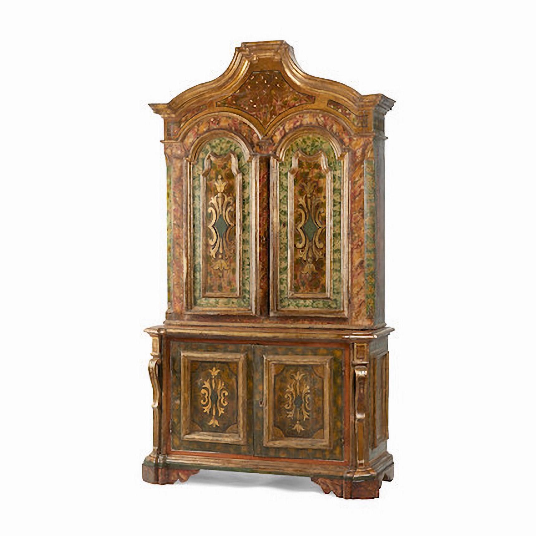 A French Baroque Style Painted and Parcel Gilt Buffet a Deux Corps, 18th Century

The graduated and shaped cornice over a pair of arch doors with raised cartouche panels of foliate design doors, opening to three internal shelves, the lower pair of