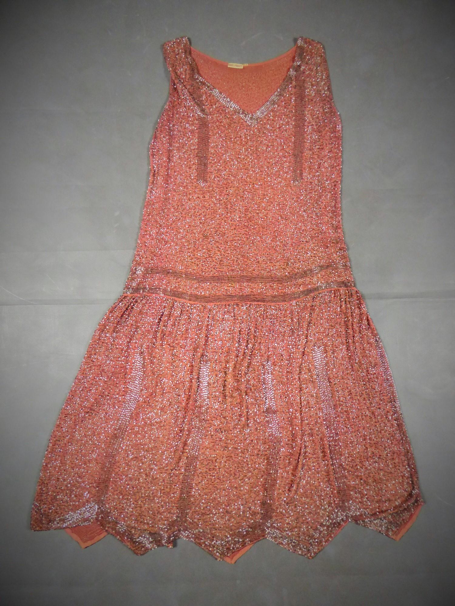 Circa 1925
France

Flapper dress in pale rose cotton Chiffon embroidered with translucent tubular glass beads dating from the French Années Folles. Embroidered and vermiculated background gives a sablé effect. Loose dress with straight cut and low