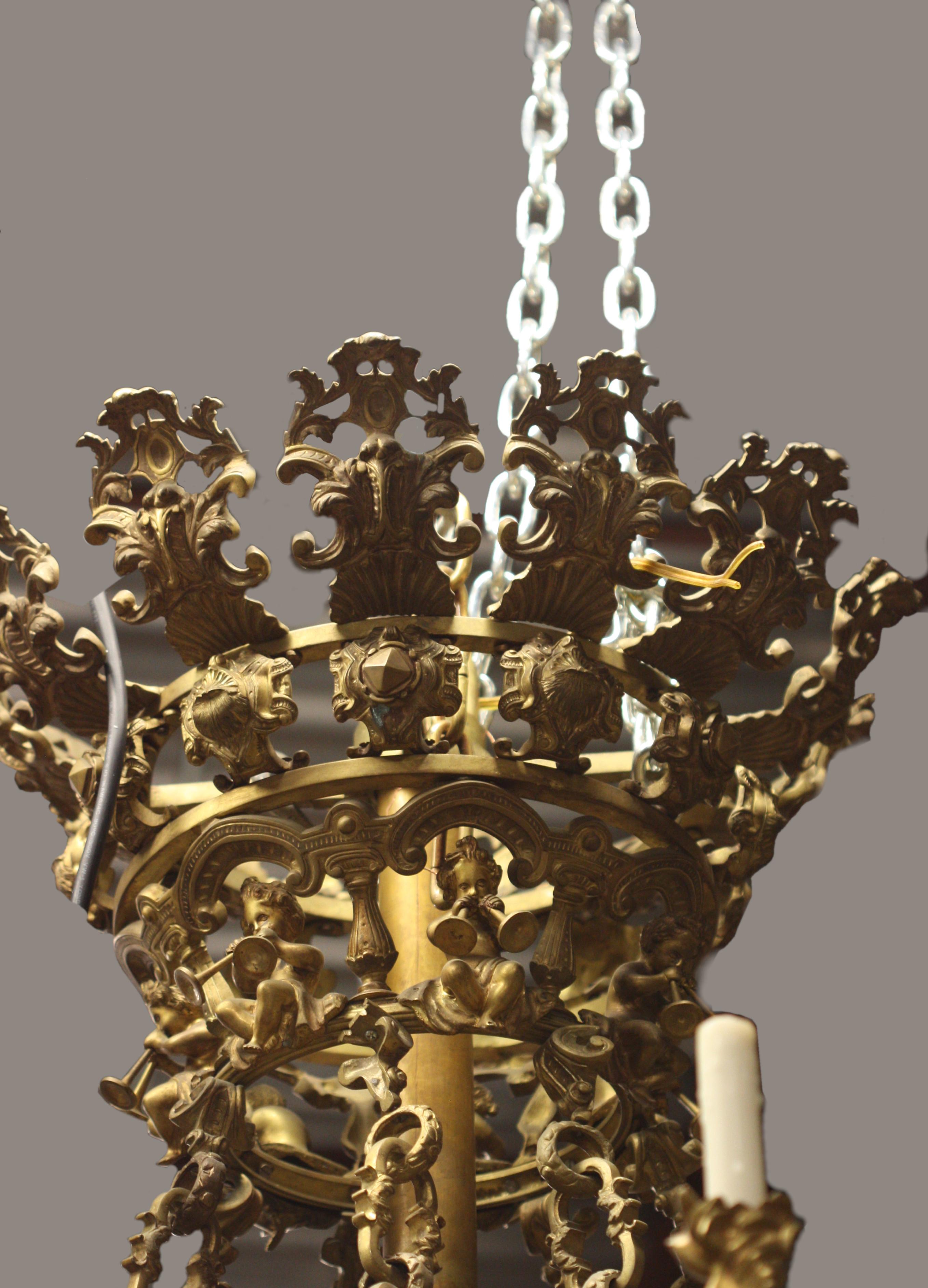A French Belle Époque gilt bronze chandelier 
late 19th century.
The corona surmounted by stylized foliate motifs, suspending an etched glass bowl within a C-scroll pierced frame, topped with acanthus leaf finials interspersed with mermaids