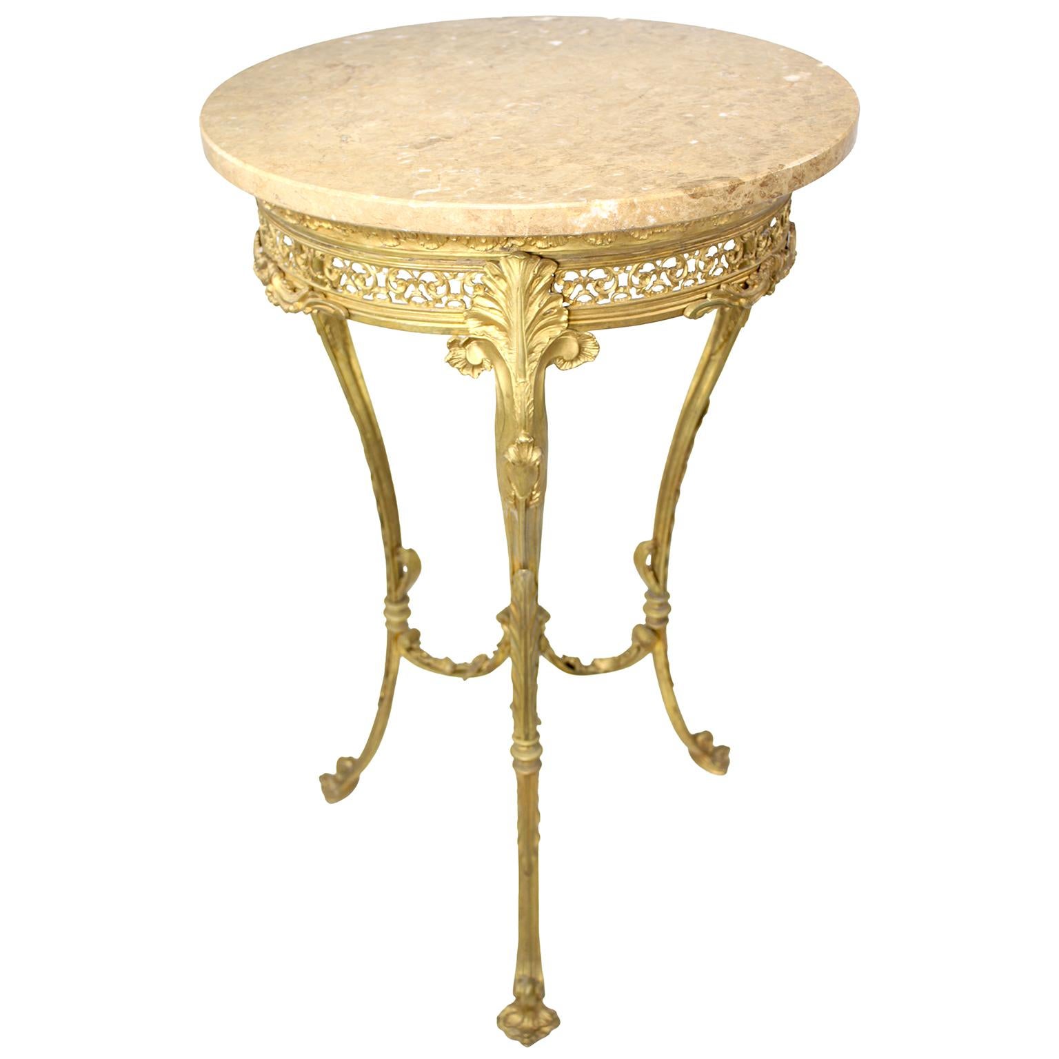 A French Belle Époque Louis XV Style Gilt-Bronze Gueridon Table with Marble Top, in the manner of Zwiener Jansen Successeur. The circular Riviera Beige marble top above a three-leg ormolu base with a pierced floral apron below an icicle trim,