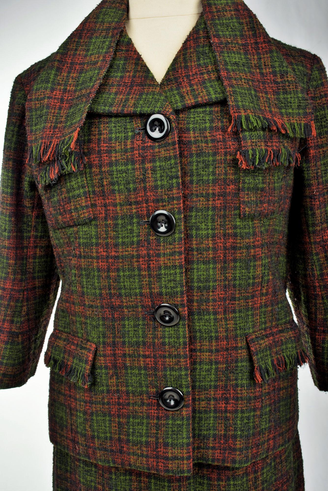 Circa 1970
France

Tartan plaid curly wool suit labelled Berenice which belongs to a series of Christian Dior patterns, made by this Marseilles-based House and dating from the 1970s. Fitted jacket with fringed shawl collar integrated to tie with