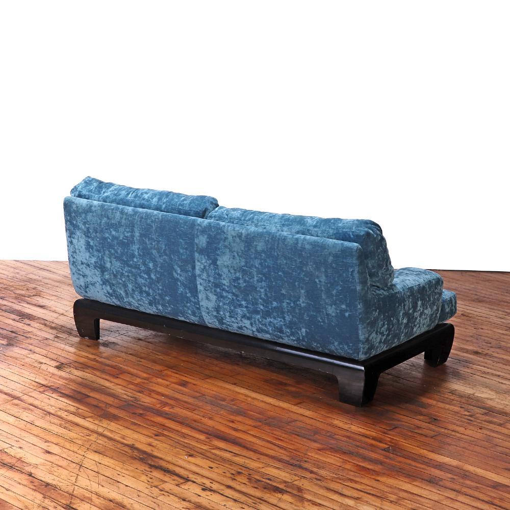 Un sofá francés chic y sofisticado, de hacia 1960, tapizado en rico terciopelo azul con una elegante base de madera ebonizada. La silueta de perfil bajo y las líneas limpias reflejan el refinado modernismo del diseño francés de mediados de siglo,