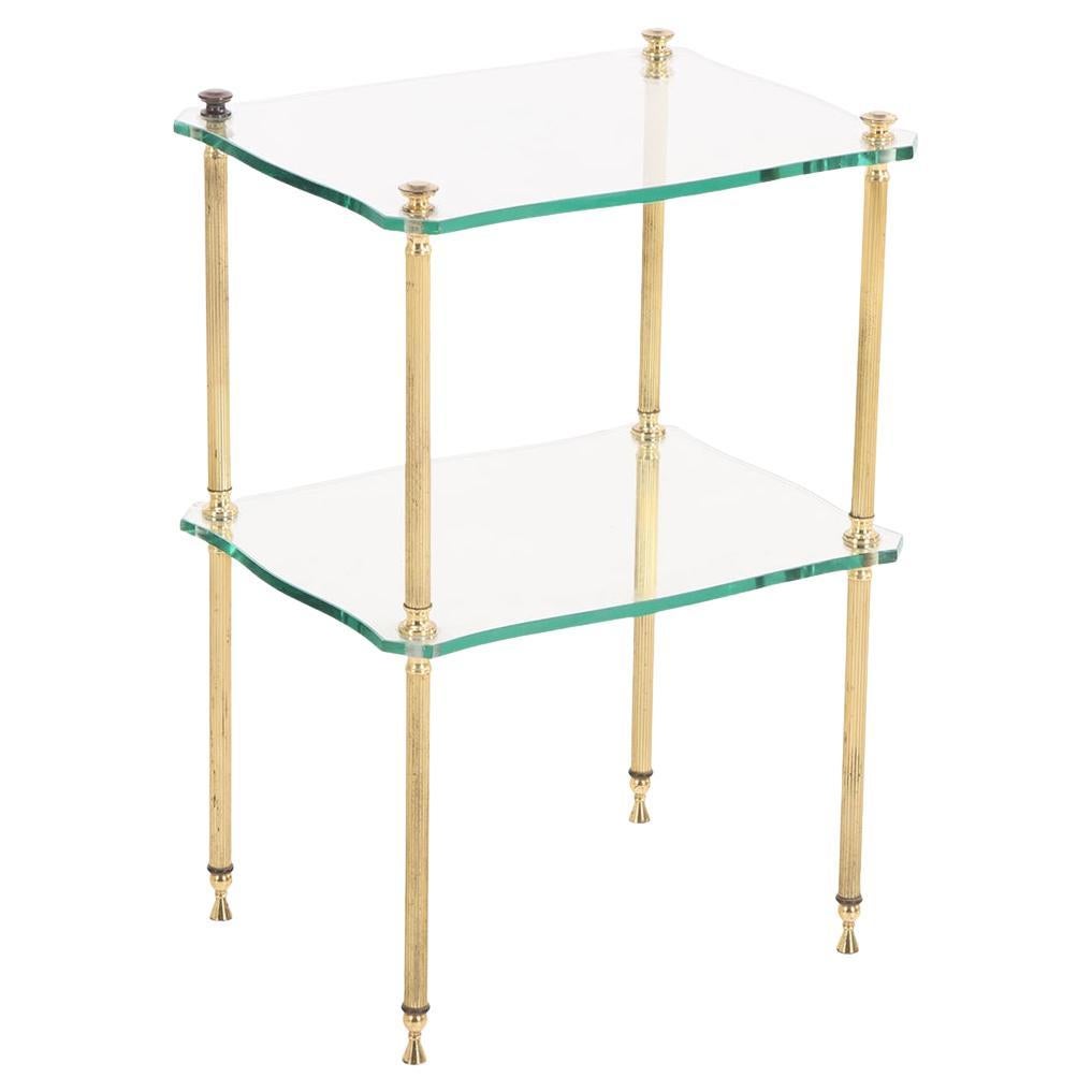 A French brass and glass tiered end table, C. 1960. For Sale