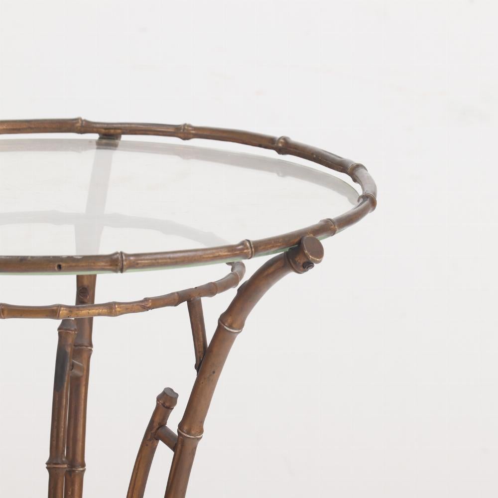 Having a round glass top inset in a brass tripod base, this Asian inspired table is a well-placed addition in any décor. This is a perfect place to show off a beautiful orchid or display a favorite decorative object anywhere in your home.