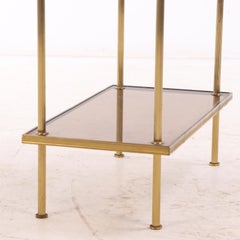 A French brass two tier table C 1950 in the manner of Jansen.