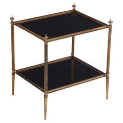 A French brass two tiered end table in the manner of Maison Jansen,  C 1940.