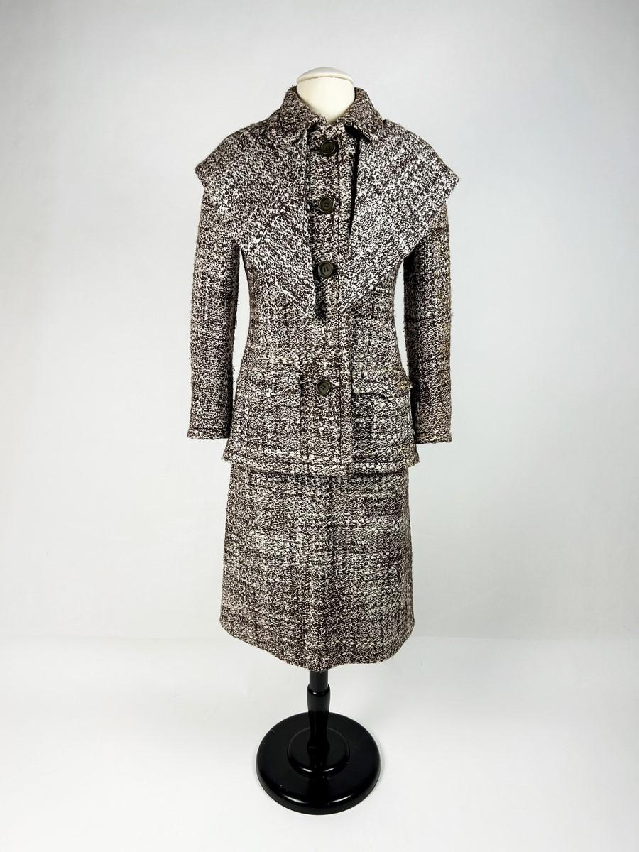 Circa 1975

France

A brown and white Chiné mohair wool skirt suit from the Parisian label Veronese dating from the 1970s. Straight jacket with long sleeves and a small turned-down collar fastened with five brown resin buttons. Wide topstitching all