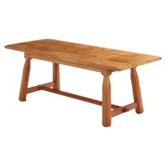 A French Brutalist style solid oak dining table, C. 1950.