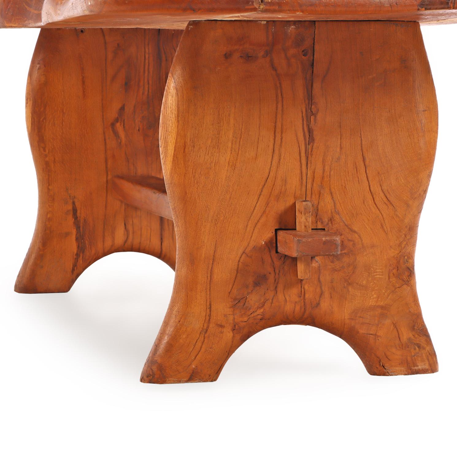The organic silhouette from the natural edge—following the tree’s original contours—adds movement and warmth, while the substantial slab of wood gives a grounded, sculptural quality. Crafted of a thick slab supported by a trestle base with two