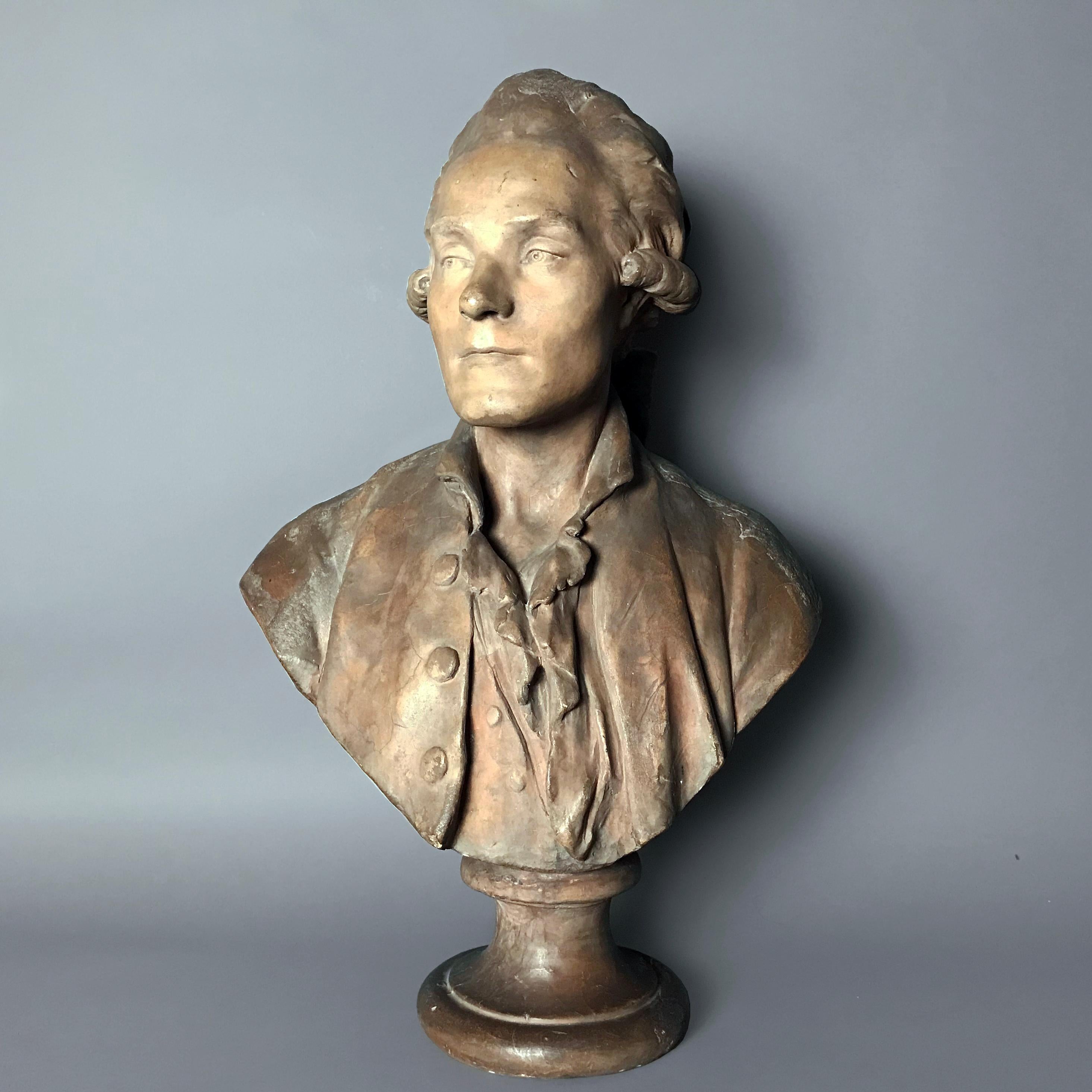 After a model attributed to Jean Antoine Houdon, possibly Nicolas Joseph Laurent Gilbert (1750 - 1780), poet.

Superbly sculpted in a coat and ruffled shirt set on a waisted socle. The rear of the bust showing the sculptor's thumb-prints where he