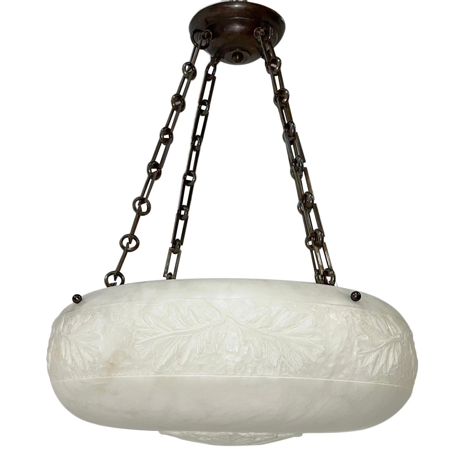 A circa 1940's French carved alabaster pendant light fixture with 4 interior lights.

Measurements:
Current drop: 26