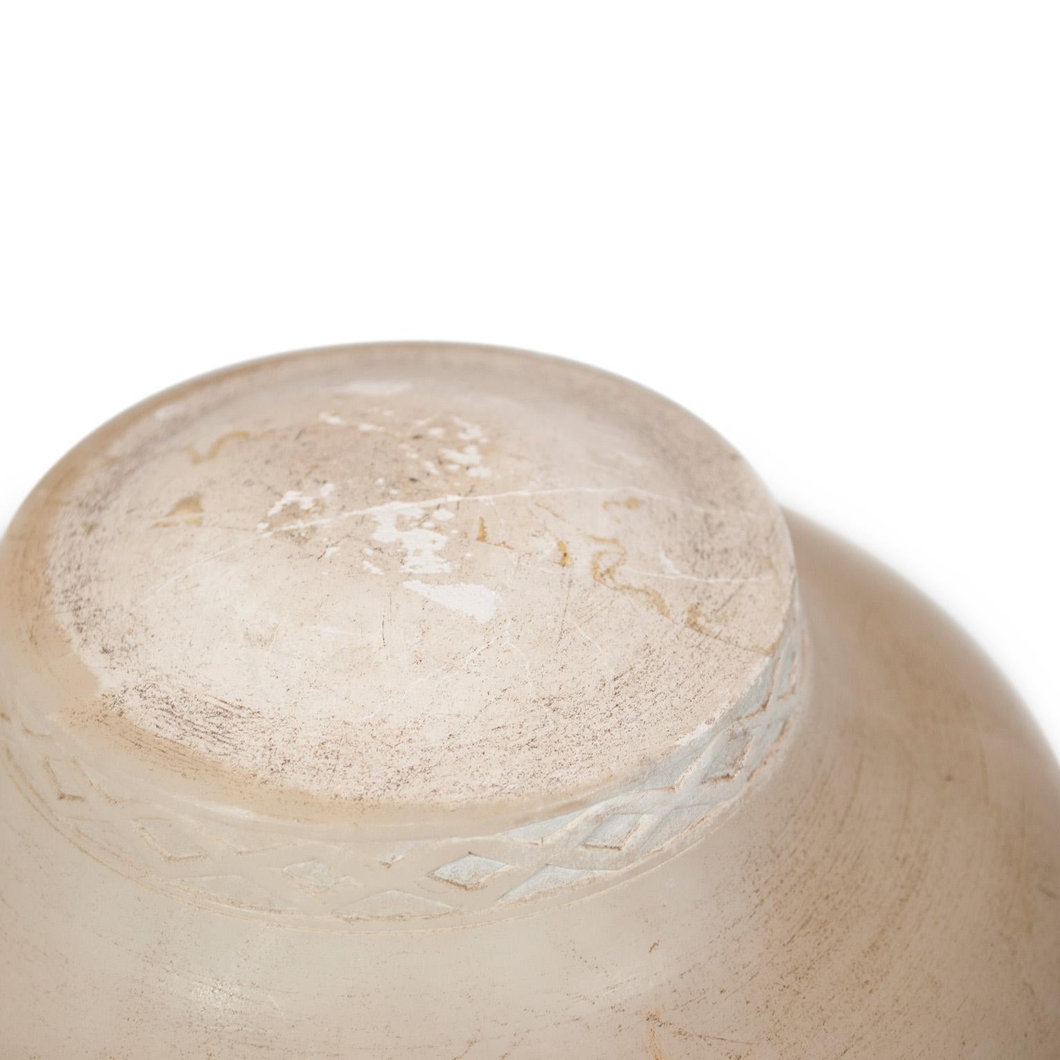 A carved alabaster table lamp and circular bowl-form shade, with fluted body and tripod paw-foot base.