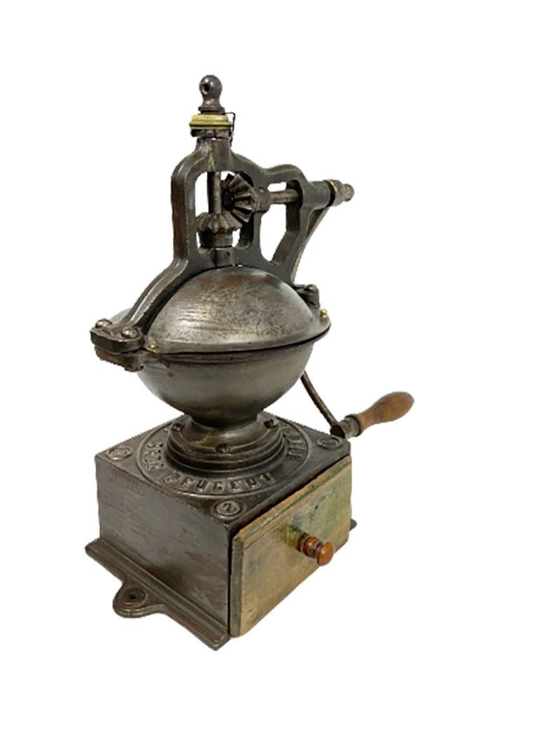 A French cast iron coffee grinder, late 19th century

A French coffee grinder A2 of the brand Peugeot, Freres Brevetes S.G.D.G. no. 2A late 19th century.

This type of coffee grinder was used in shops in the past and has a crank with a wooden