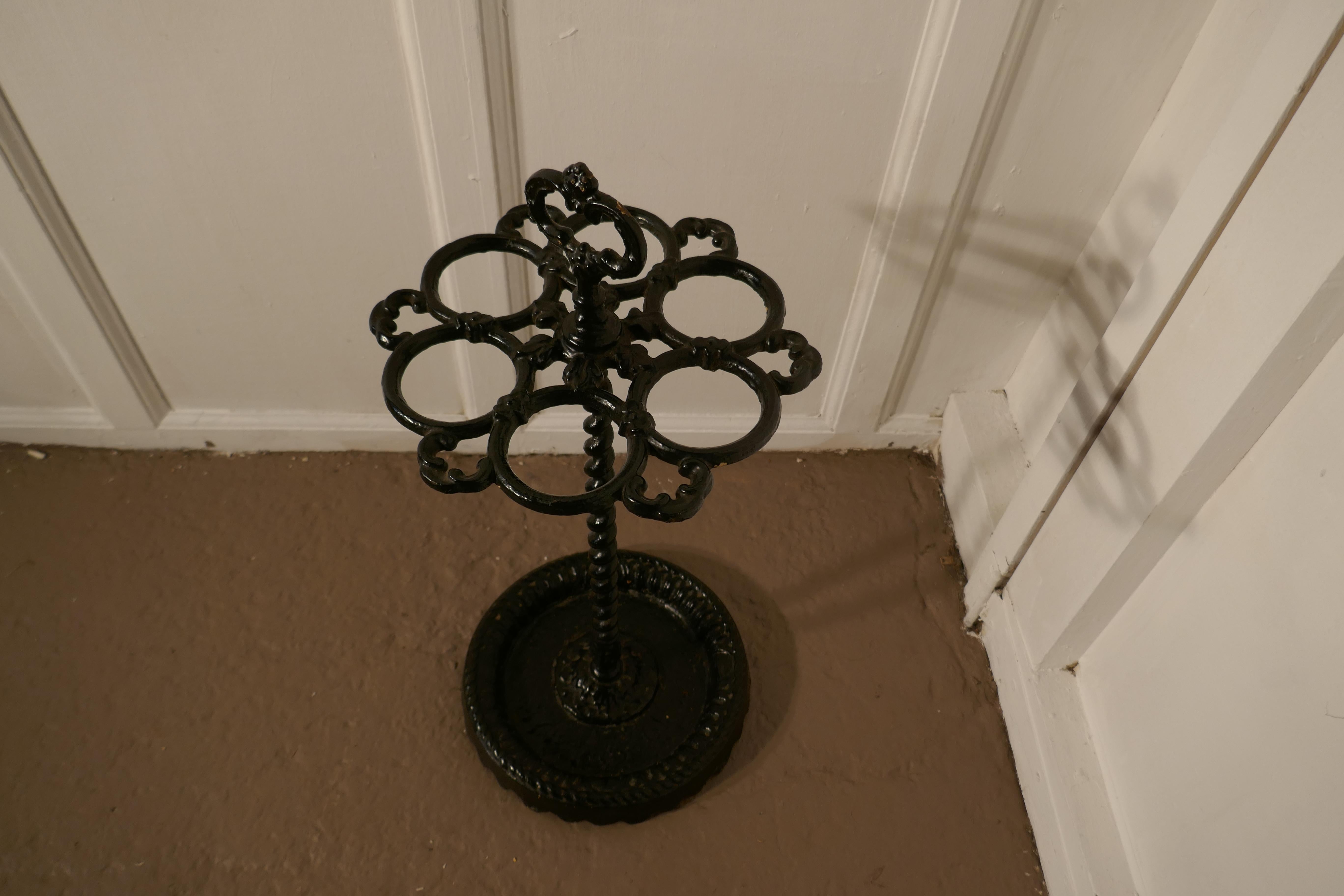 A French cast iron walking stick stand or umbrella stand

A charming piece, the round stand is divided into 6 sections to hold either walking sticks or umbrellas, the heavy iron base is also the drip tray and it has a handle on the top
The stand