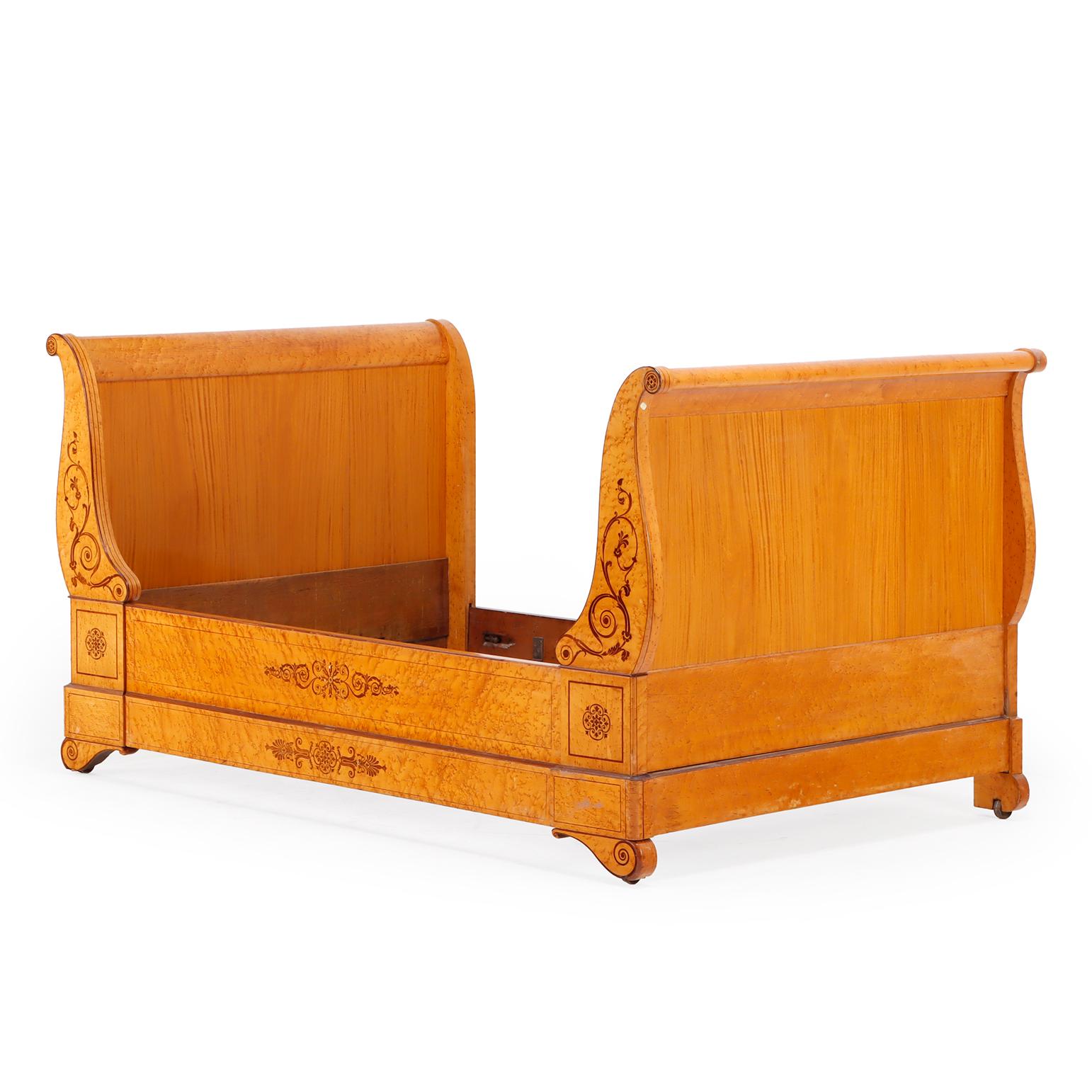Beautifully crafted from birdseye maple with fine inlay detailing,  the elegant, symmetrical form features scrolled ends and a gently curved frame, characteristic of the late Empire to early Louis-Philippe transition. The light tone and figured