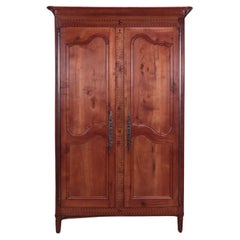 A French cherry armoire with banded inlay, C 1800.