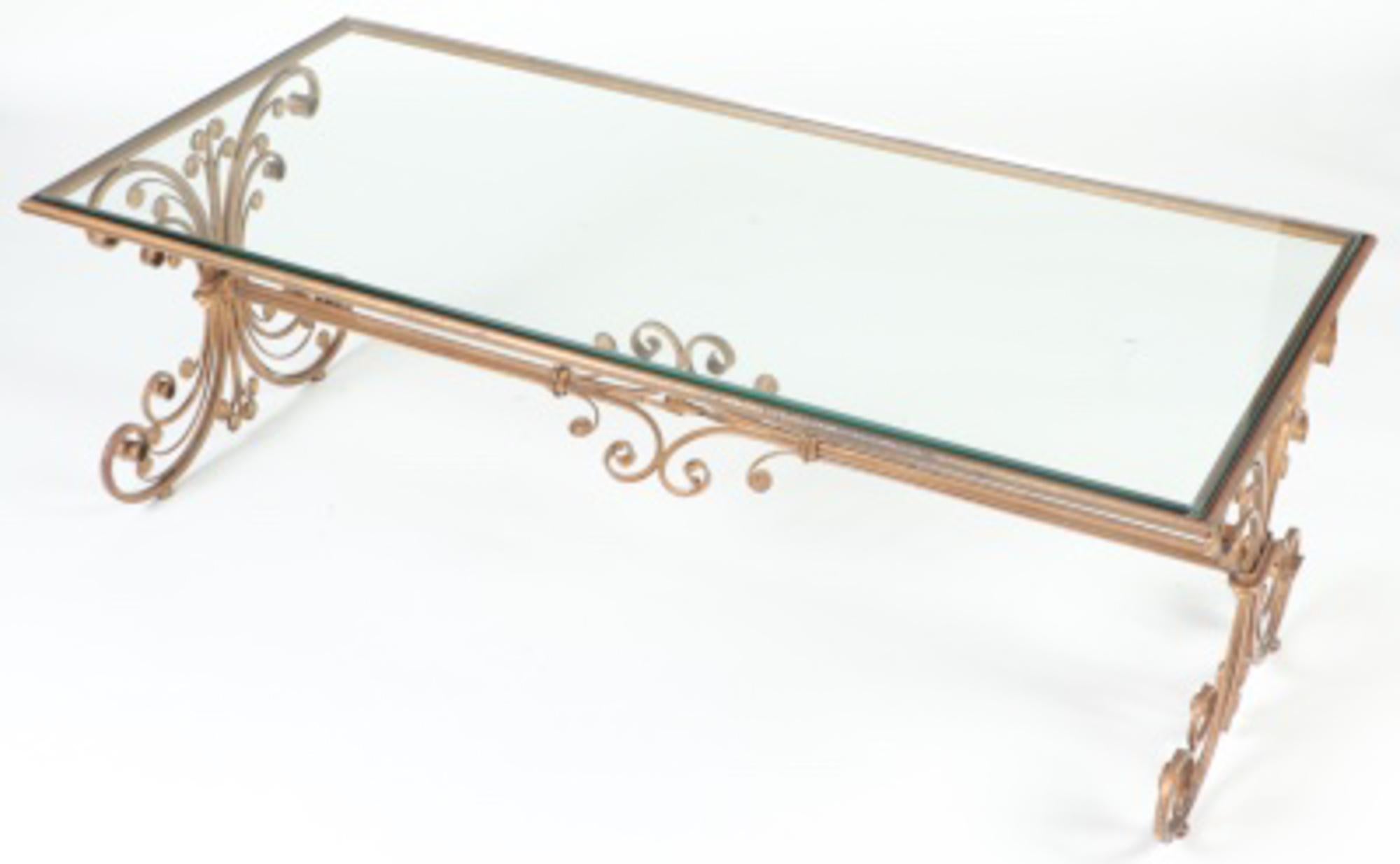 A French cocktail or coffee table with gilded iron base and glass top, having scrolled feet. Circa 1960.
We are located in Philadelphia and offer expedited shipping to the NYC area on many of our items.