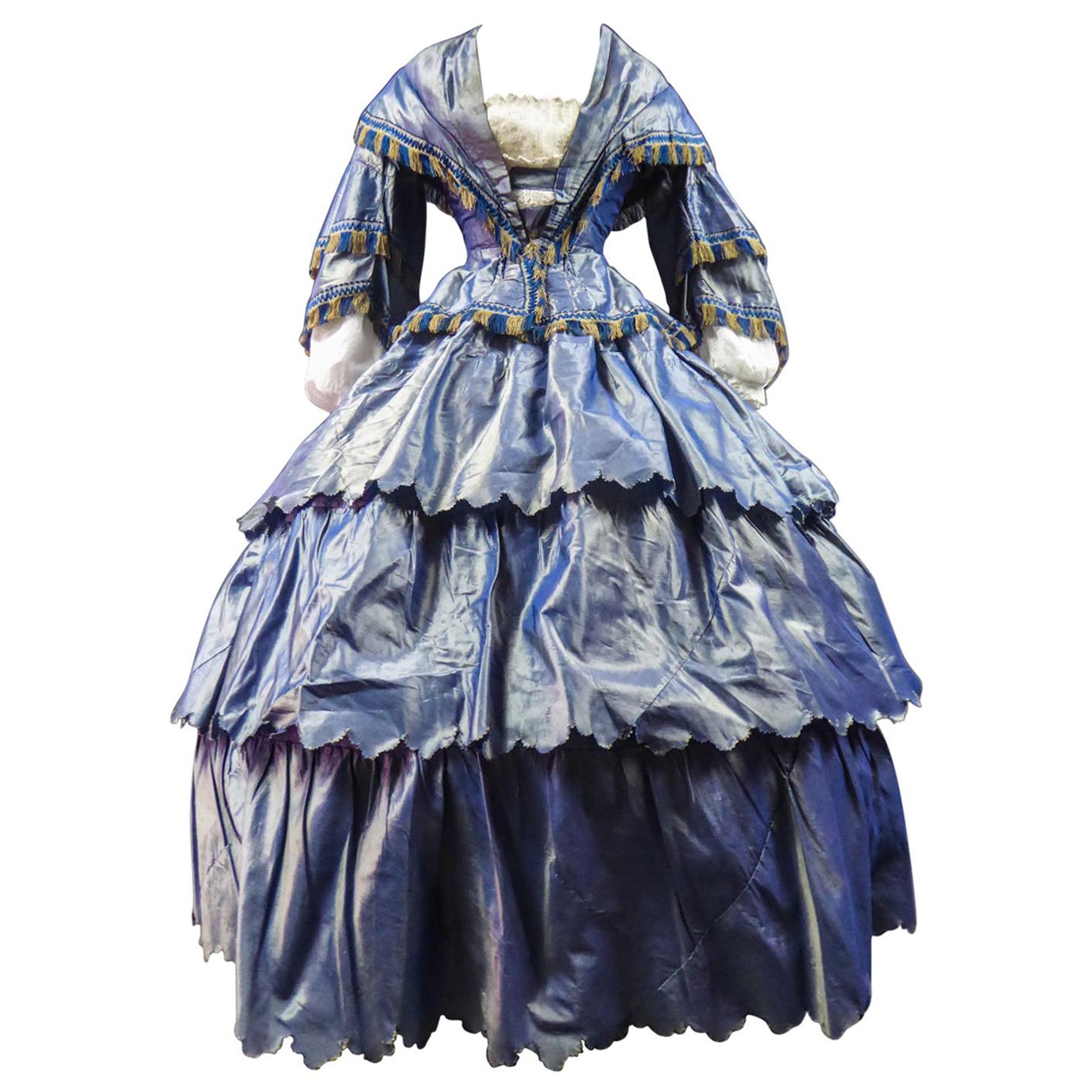 Vers 1855
France

Robe de jour française avec corsage et jupe ronde à crinoline en taffetas changeant et bruyant datant du début du Second Empire français. Corsage désossé avec capelet plissé intégré et grandes basques avec nœud en taffetas dans le