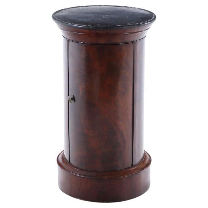 A French crotch mahogany marble top cylindrical cabinet C 1840.