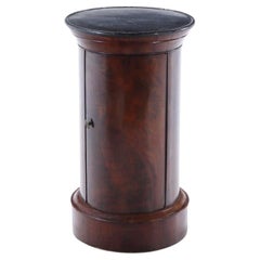 A French crotch mahogany marble top cylindrical cabinet C 1840.