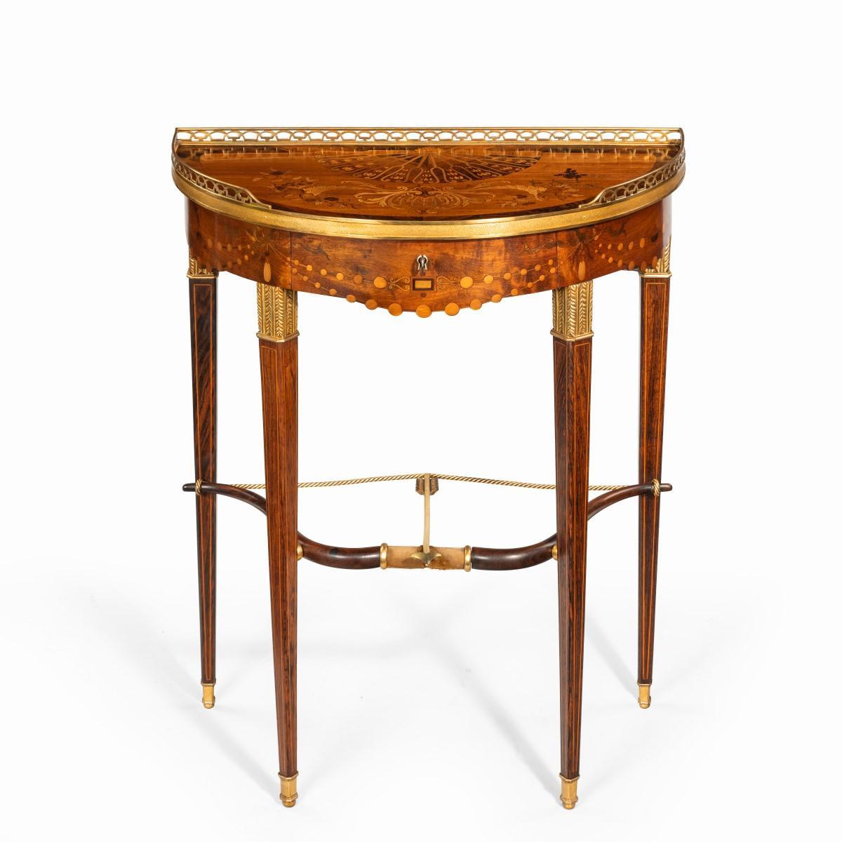 A French demilune rosewood bow and arrow table by Georges-François Alix, the hemispherical top with an ormolu gallery and disguised frieze drawer, all raised on four stylised quivers joined by a drawn bow and ormolu arrow, inlaid throughout with a