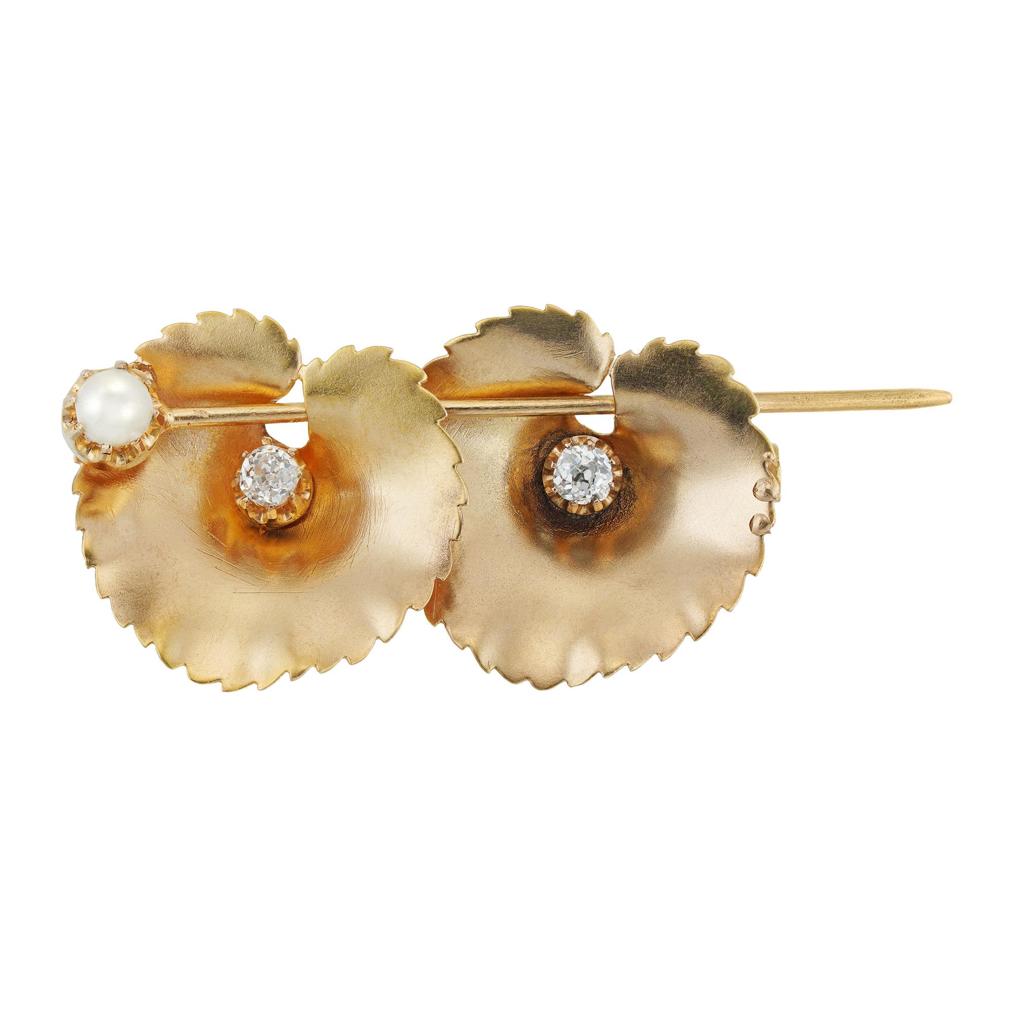 A French double lillypad brooch, the gold carved lillypads set with old brilliant-cut diamonds pierced by a gold bar decorated with a pearl, circa 1900, measuring approximately 4.7x2cm gross weight 6.0 grams.

This lovely antique turn of the century