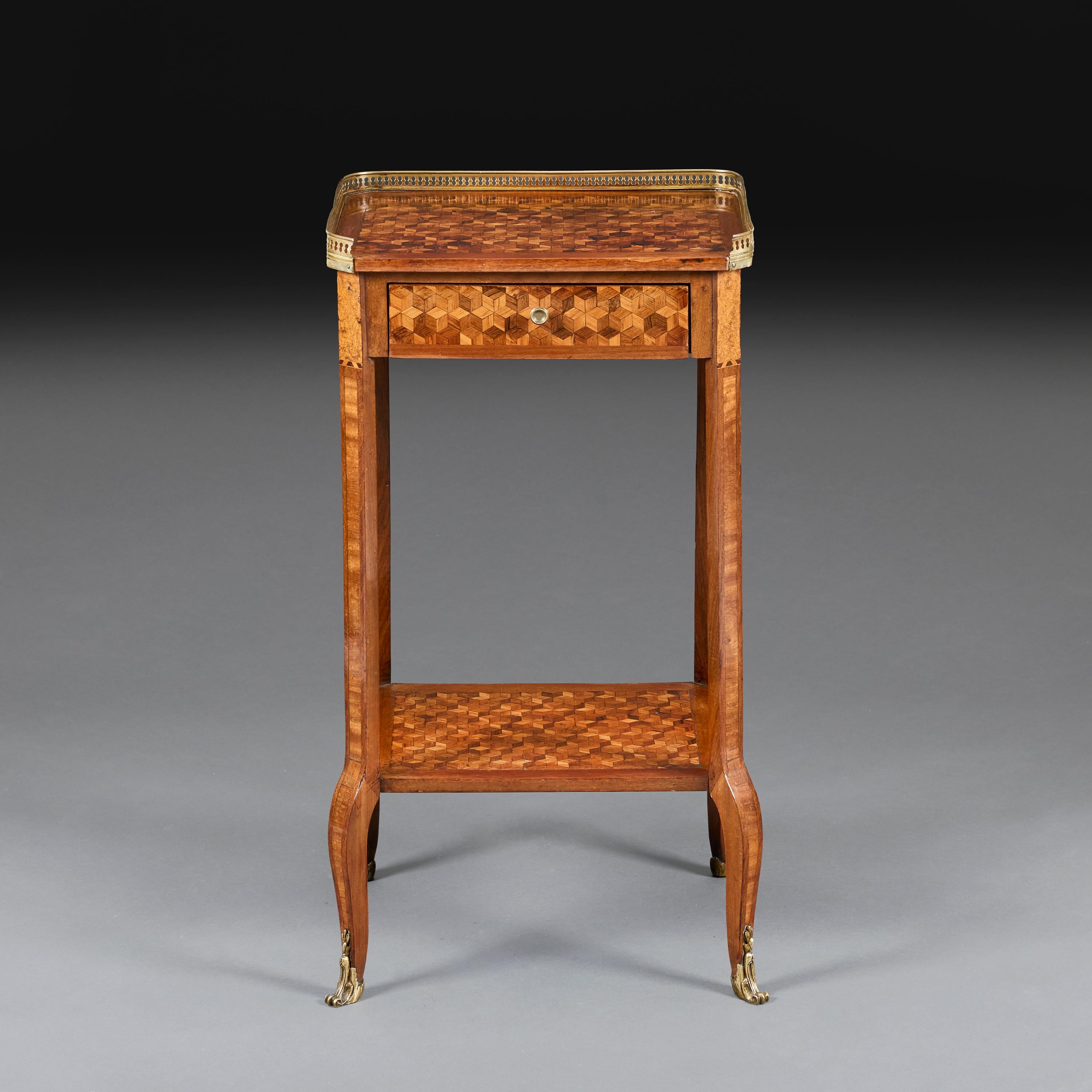 France, circa 1830.

A French early nineteenth century occasional table or bedside table with parquetry decoration in exotic timbers, the top with pierced brass gallery and burr elm corners, with slide to the right hand side for a candle, the legs