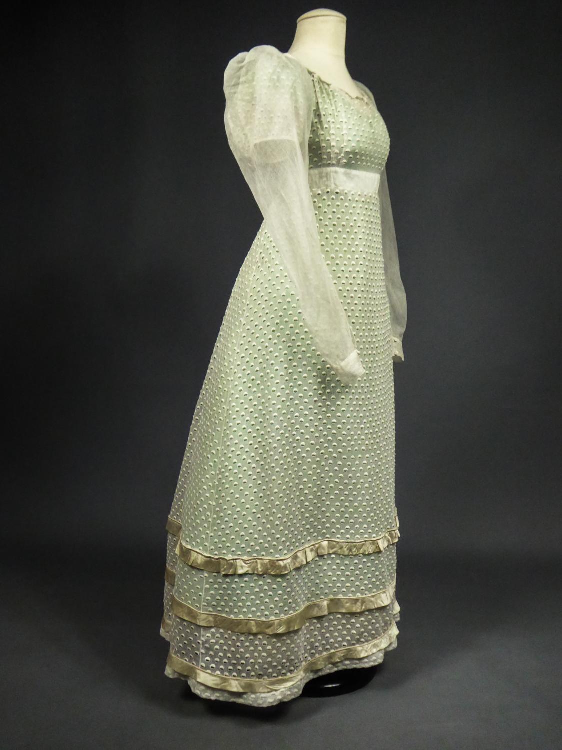 Circa 1815/1820.
France

Day dress in white embroidery or Broderie Anglaise in cotton chiffon openwork of a semis of embroidered circles revealing the color of the underdress ( not included in the sale). Curved bodice with high waist and pleated