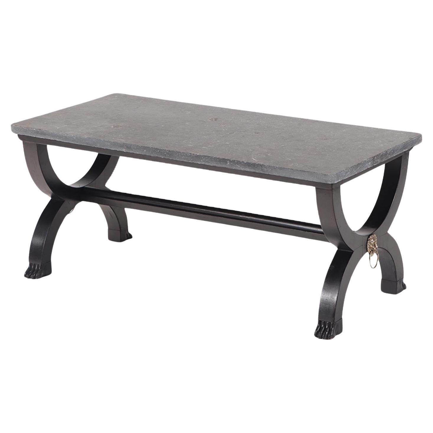 A French ebonized Empire style marble top coffee table with bronze mounts. 
