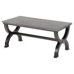 A French ebonized Empire style marble top coffee table with bronze mounts. 