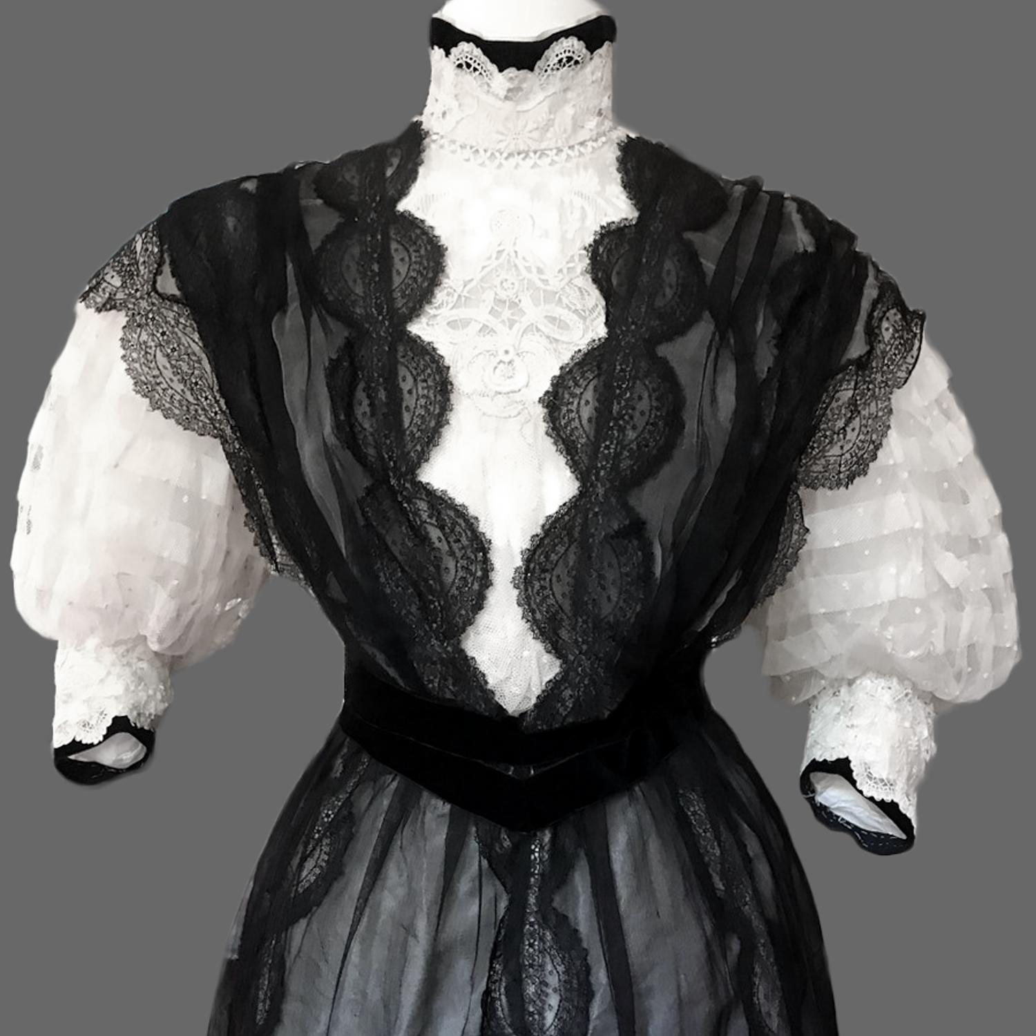 Circa 1895/1905
France

A French Tea-Gown with train in black and white muslin and lace dating from the French Belle Epoque or Edwardian Period. Background in black muslin sewn with lace arranged in river. Boned bodice with a waistband without