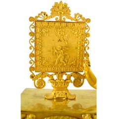 French Empire Clock Depicting a Standing Cupid and His Tools of Love