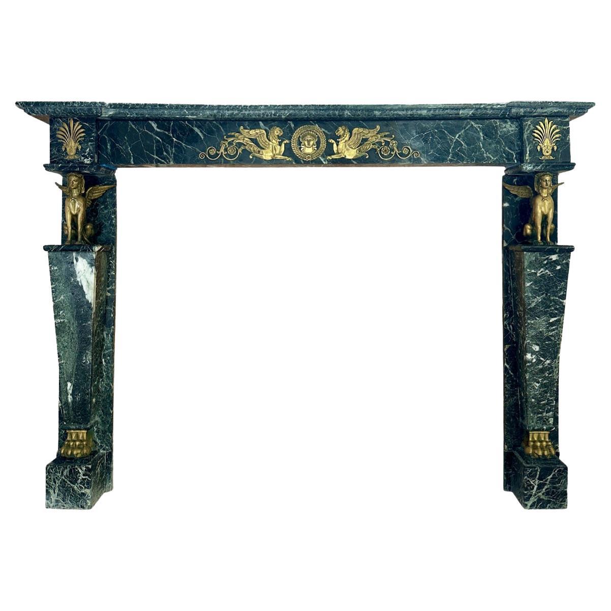 A French Empire Egyptian Revival Marble and Ormolu Fireplace Mantel