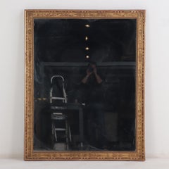 A French Empire gold mirror, 19th C.