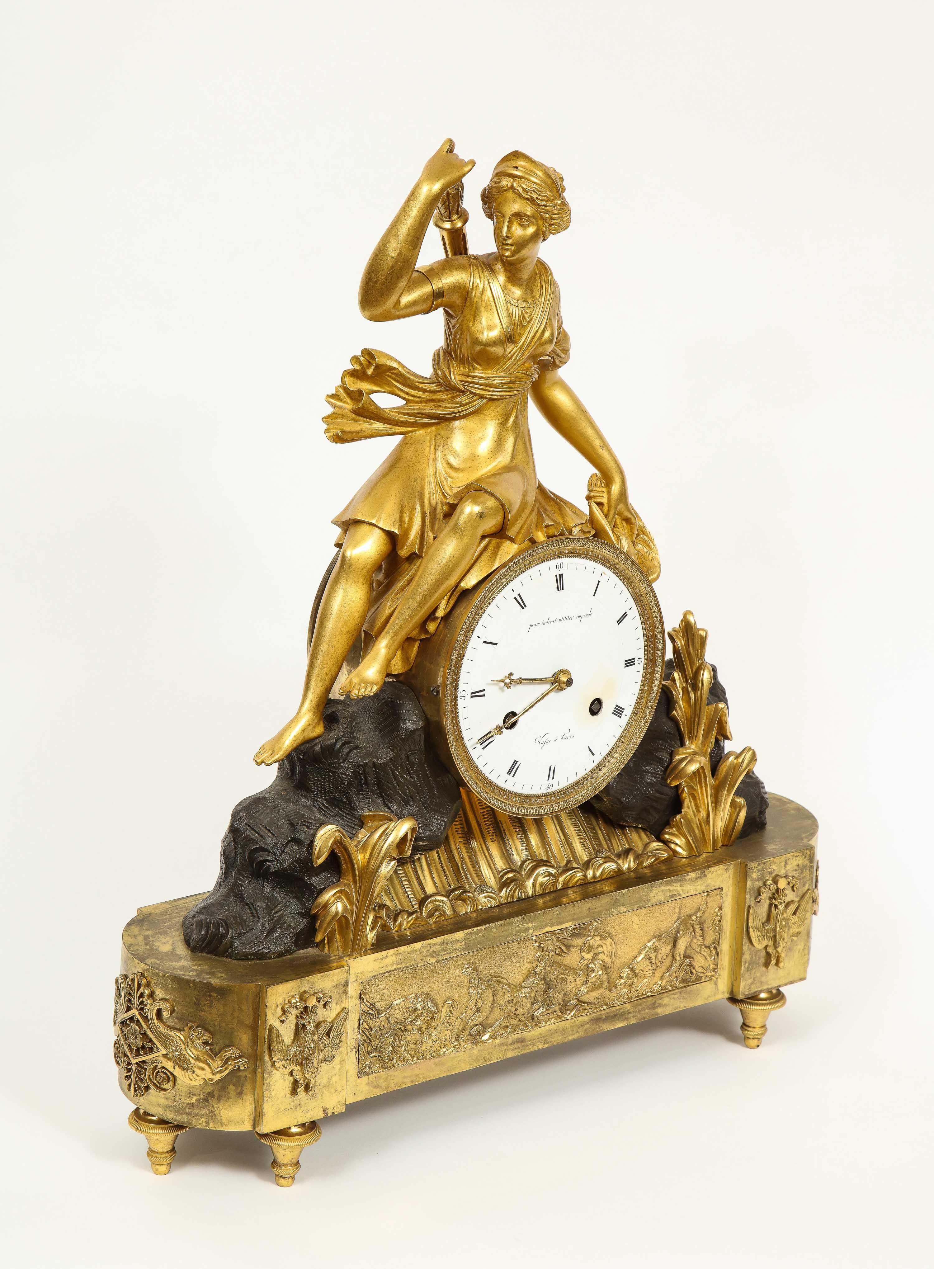 A French Empire ormolu and patinated bronze mantel (fireplace) clock with huntress diana, circa 1805.

The clock dial signed 'Vasse à Paris', and with the inscription 'quam indicat utiliter impende' ('what it shows, use to advantage') bell