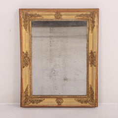 A French Empire small giltwood and gesso decorated mirror, 19th C.