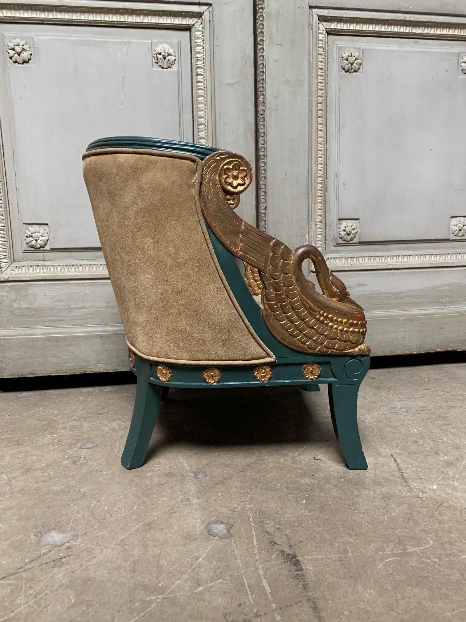 This charming diminutive French Empire style child’s chair is painted in teal blue and gold and features beautifully carved swans as arms and rosettes throughout the apron.