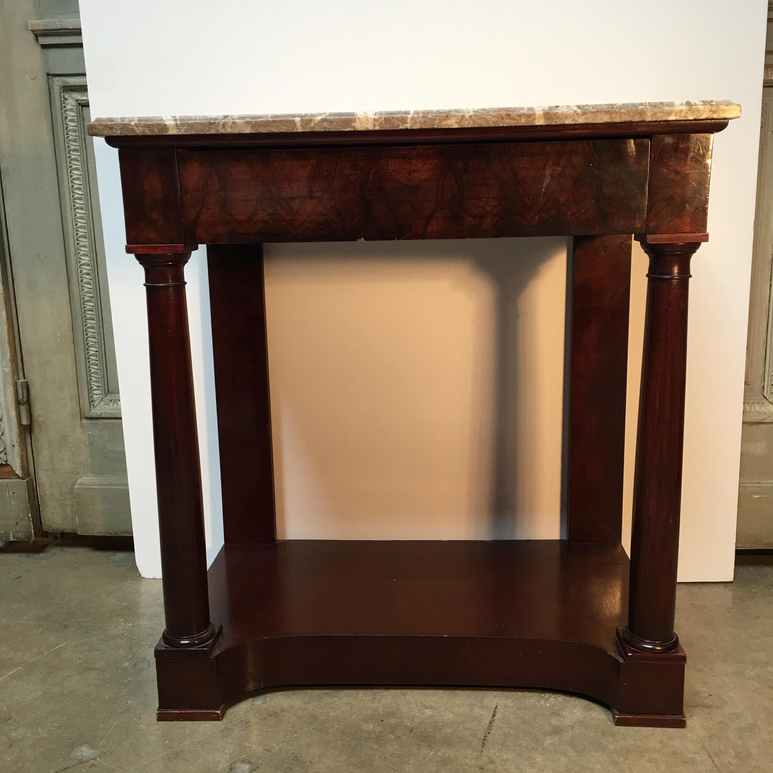 A French Empire style mahogany console with marble top.