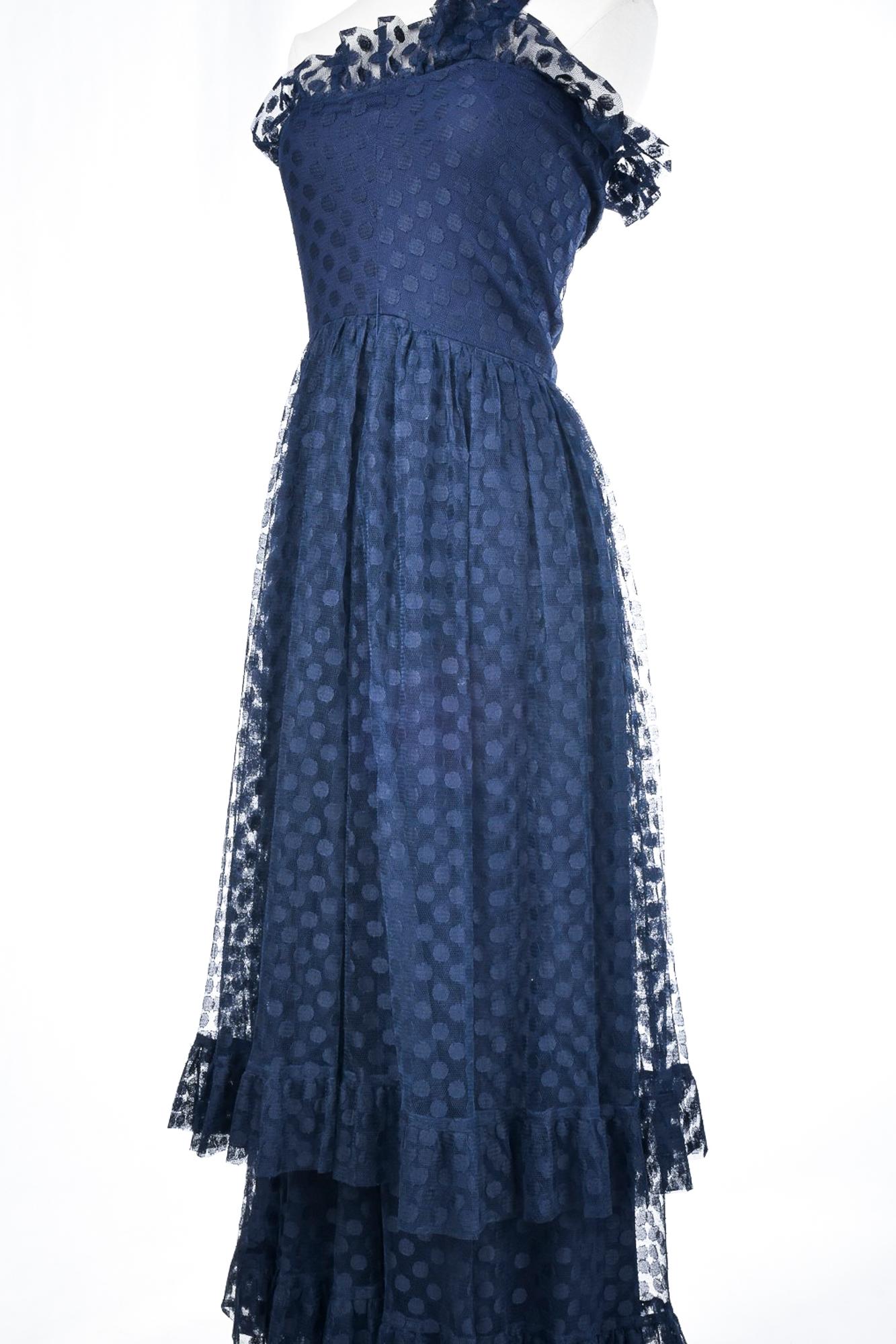 Circa 1980

France

Beautiful evening dress in navy blue Polyamide tulle with polka dots by Sherrer Boutique Paris numbered A13862 dating from the beginning of the Prêt-à-porter of the famous House. Asymmetrical long dress, curved bustier with large