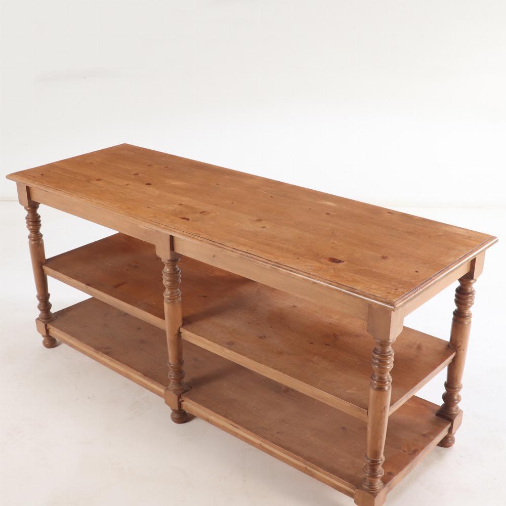 This store counter / table has beautifully turned legs supporting the large work surface and ample display below on the double shelves. The turned legs and small ball / bun feet offer a touch of the traditional.

Let this beautiful piece enhance