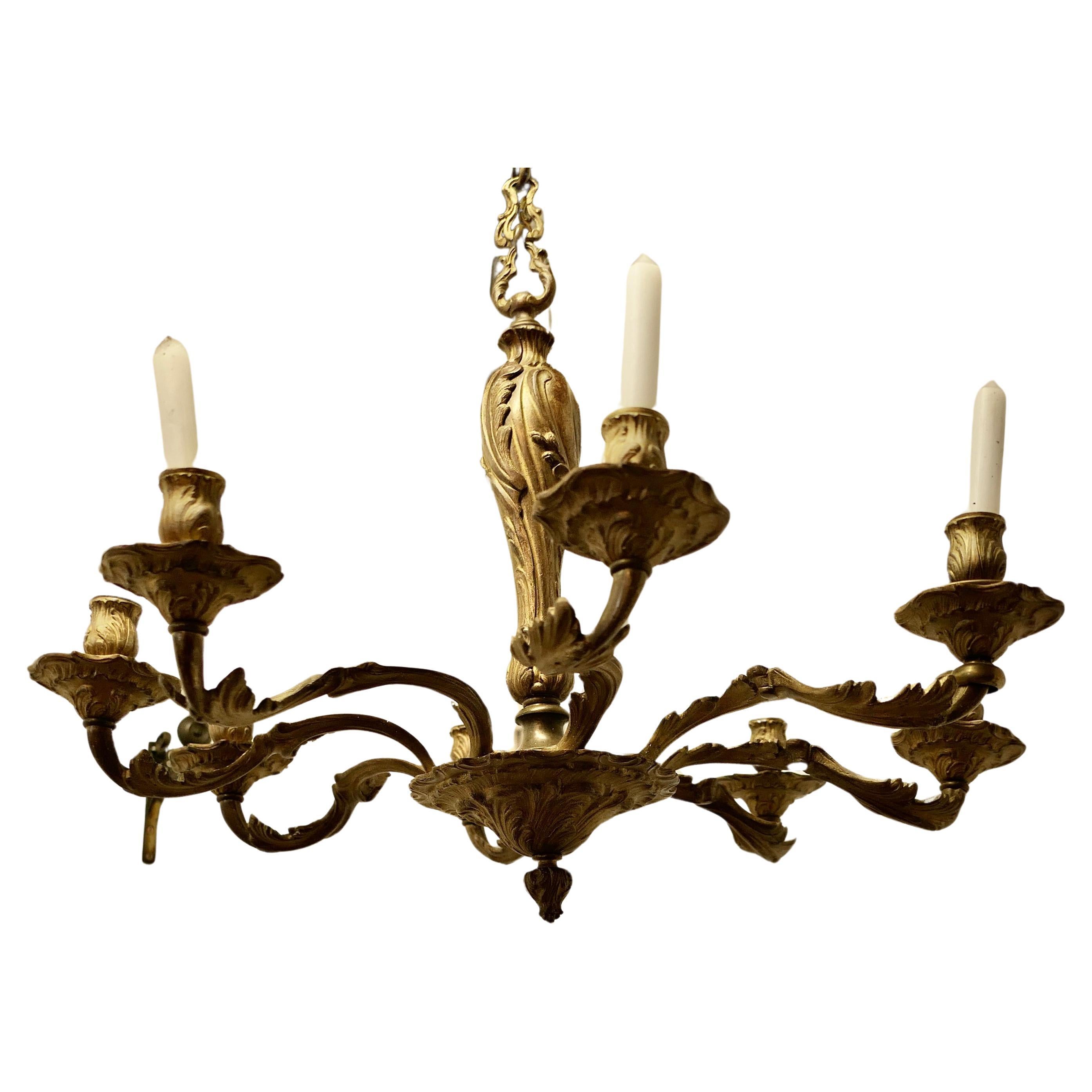 A French Gilded Brass 8 Branch Rococo Chandelier (Candelier)  