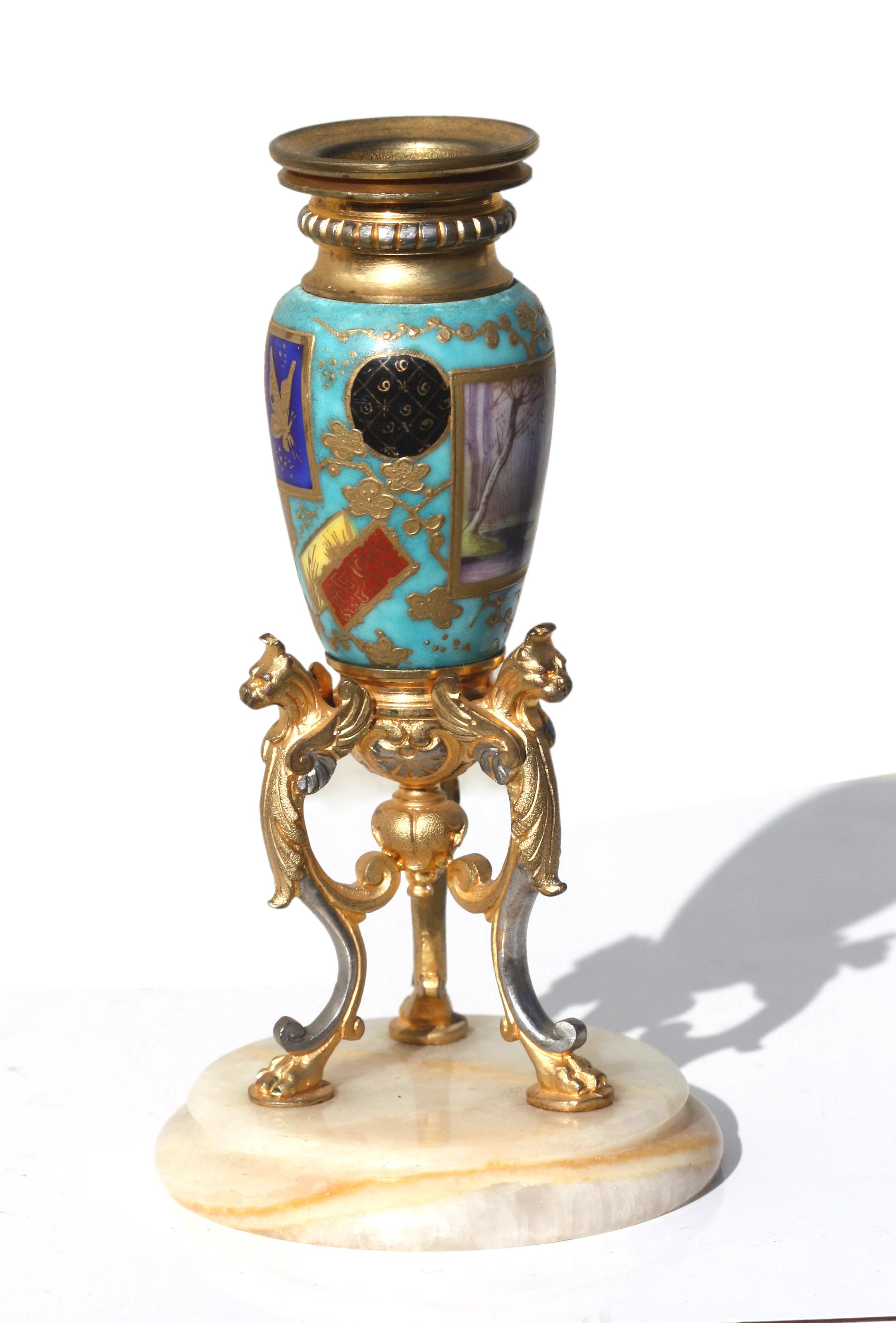 A French gilt-bronze and Sevrès style porcelain-mounted candle stick
19th century, the bronzes in Louis XV / XVI Transitional style, on a onyx stepped round base
height 6 inches, width 3 1/8 inches.
 