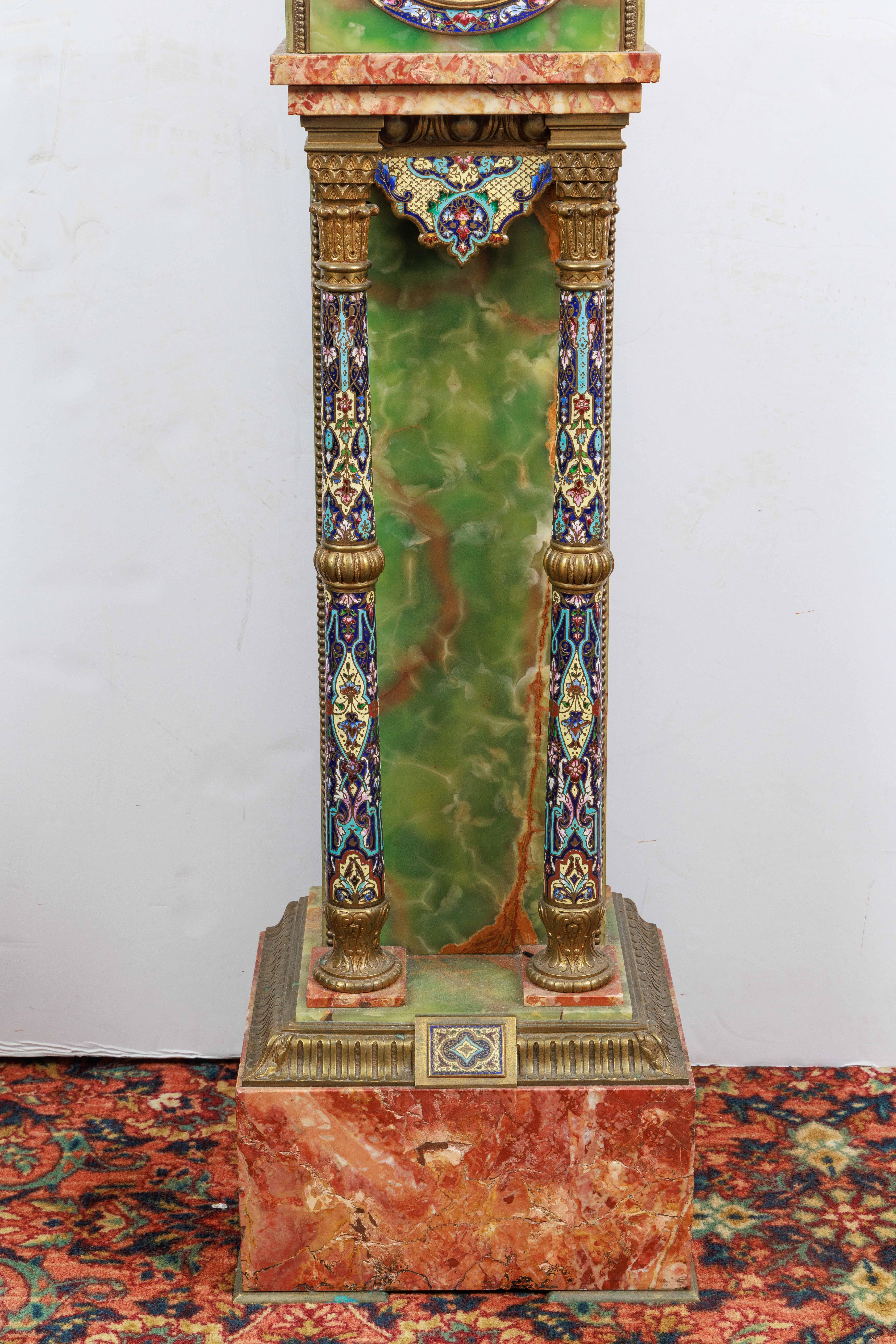 A French Gilt-Bronze, Champleve / Cloisonne Enamel, Green Onyx, and Pink Marble Pedestal Clock, C. 1880.

With a 5½-inch dial with cream enamel, the case with gilt-bronze mounts and pillars decorated with polychrome champleve enamel.

Overall in