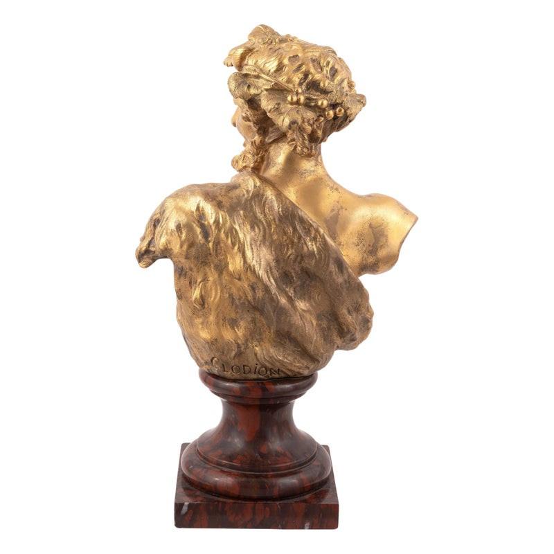 Modeled as a satyr, incised CLODION, raised on variegated red and green marble plinth.
height 13in (33cm) 33cm high, 13in high)
