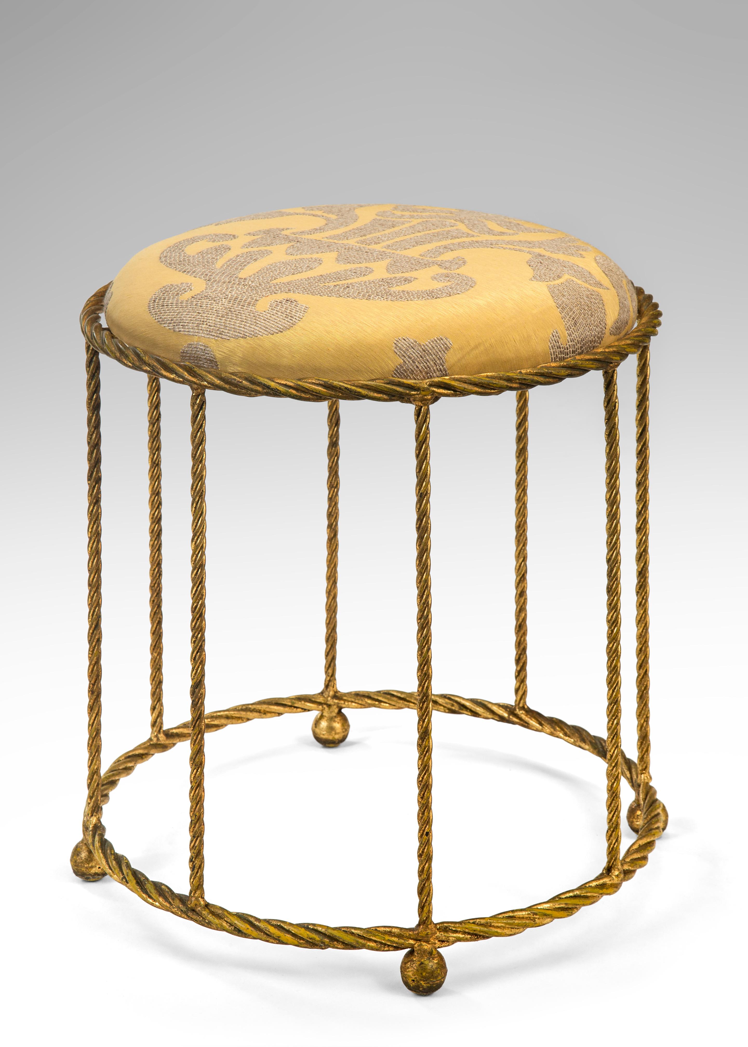 A French gilt metal rope twist stool
Mid-20th century
Get comfortable on this simple and elegant stool. The circular upholstered seat supported by the rope twist frame on spherical feet.