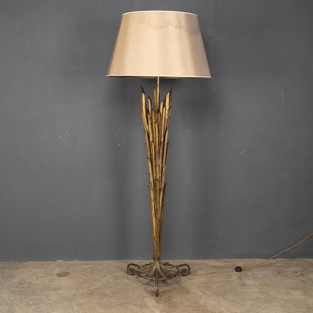 A French floor lamp with an iron scrolled base and wrought iron gilded body attributed to Maison Bagues. With a fabric and gilt lined shade.

CONDITION
In great condition - fine vintage condition, perfect working order.

SIZE
Diameter: 43cm
Height: