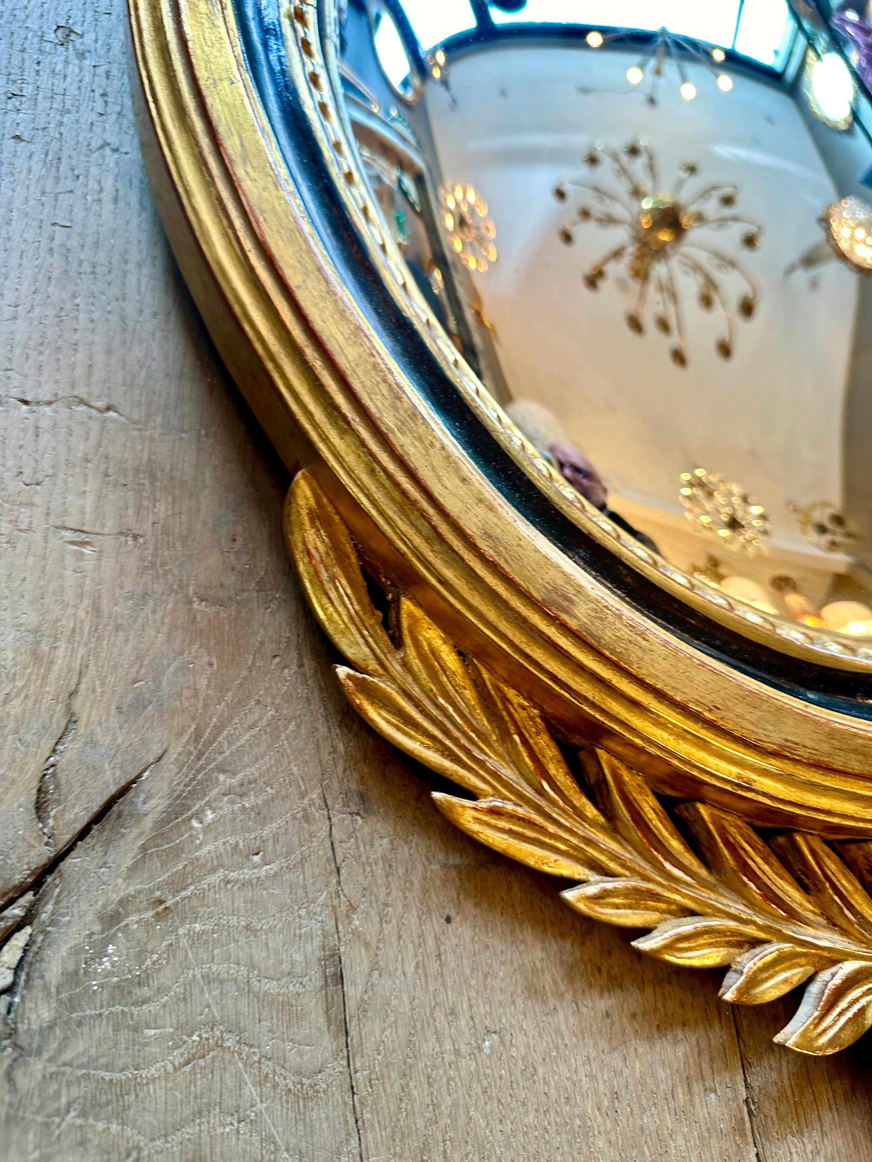 Giltwood A French Gold Gilt Oval  Convex  Eagle Crested Mirror
