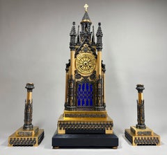 A French Gothic revival three-piece 'Cathedral' clock set circa 1850