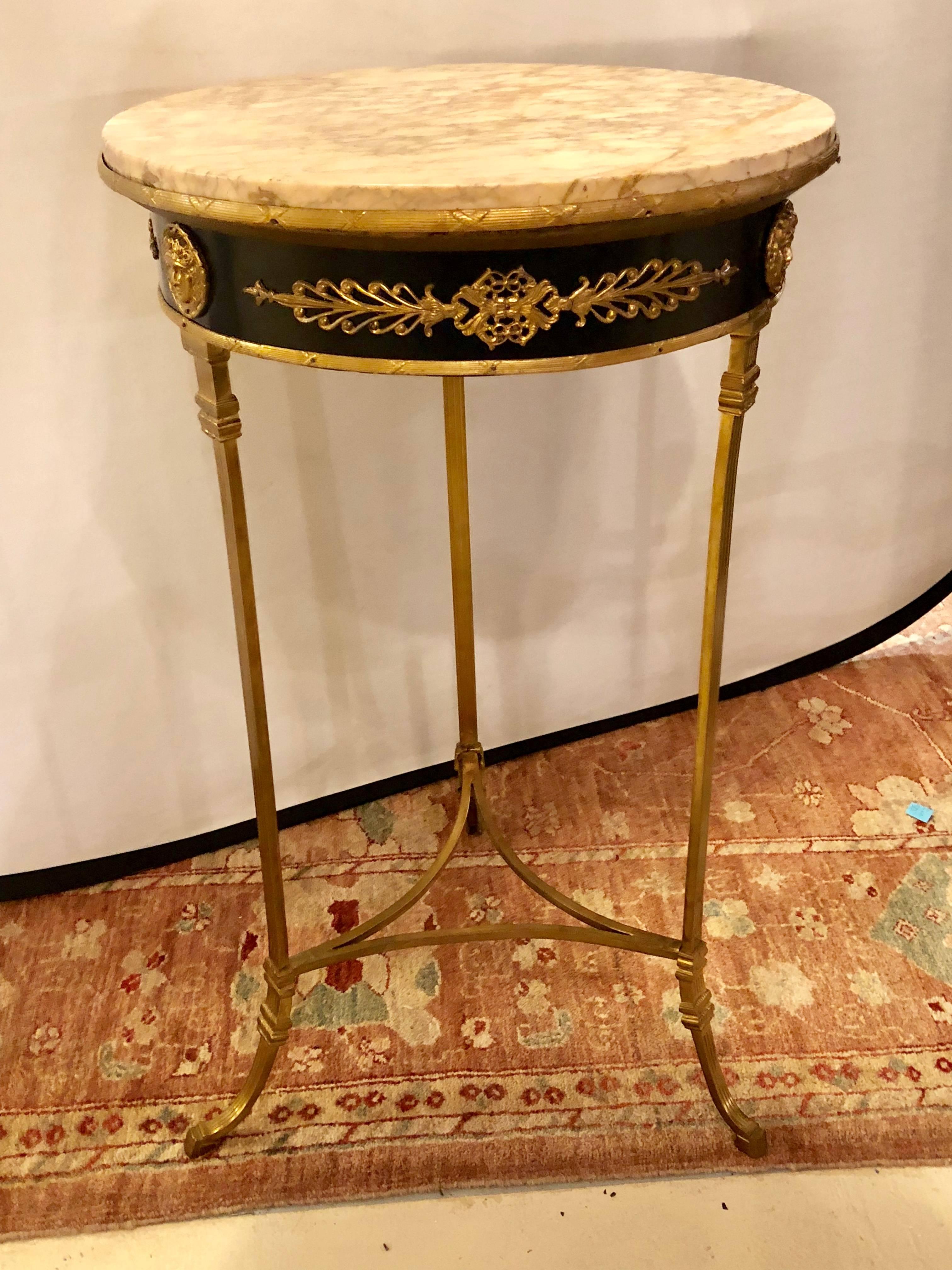 A French Gueridon centre or end table with a marble top and bronze mounts. This lovely Louis XV style Gueridon table can be used in multiple areas of the home or office and it is certain to add glamour with its fine gilt gold mounts and fashionable